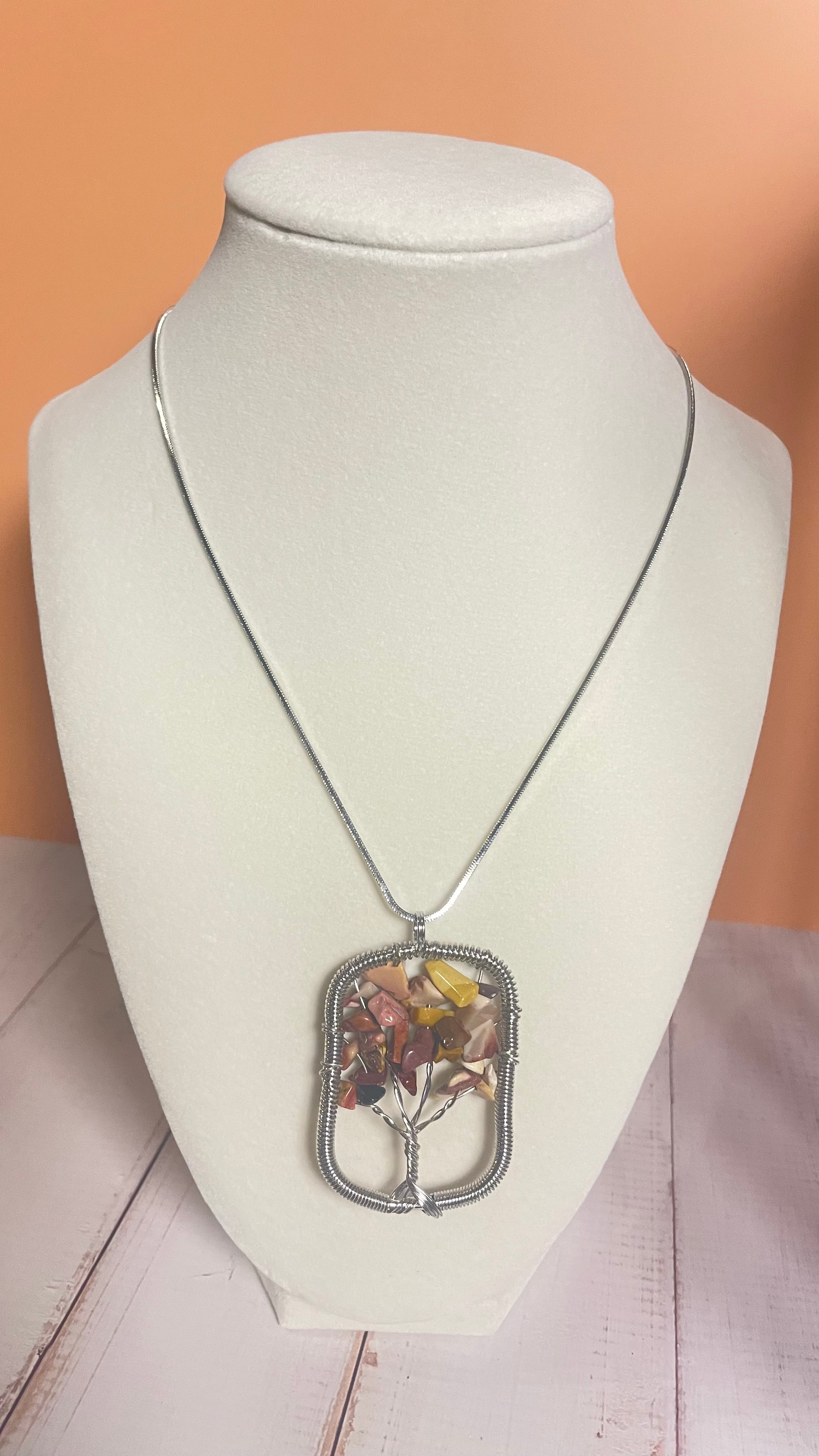Mookaite Crystal chip tree pendant on silver chain displayed on a mannequin bust